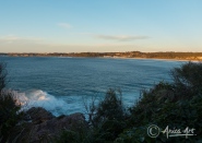 Sunrise off Bannisters Point in Mollymook with waves breaking on rocks
